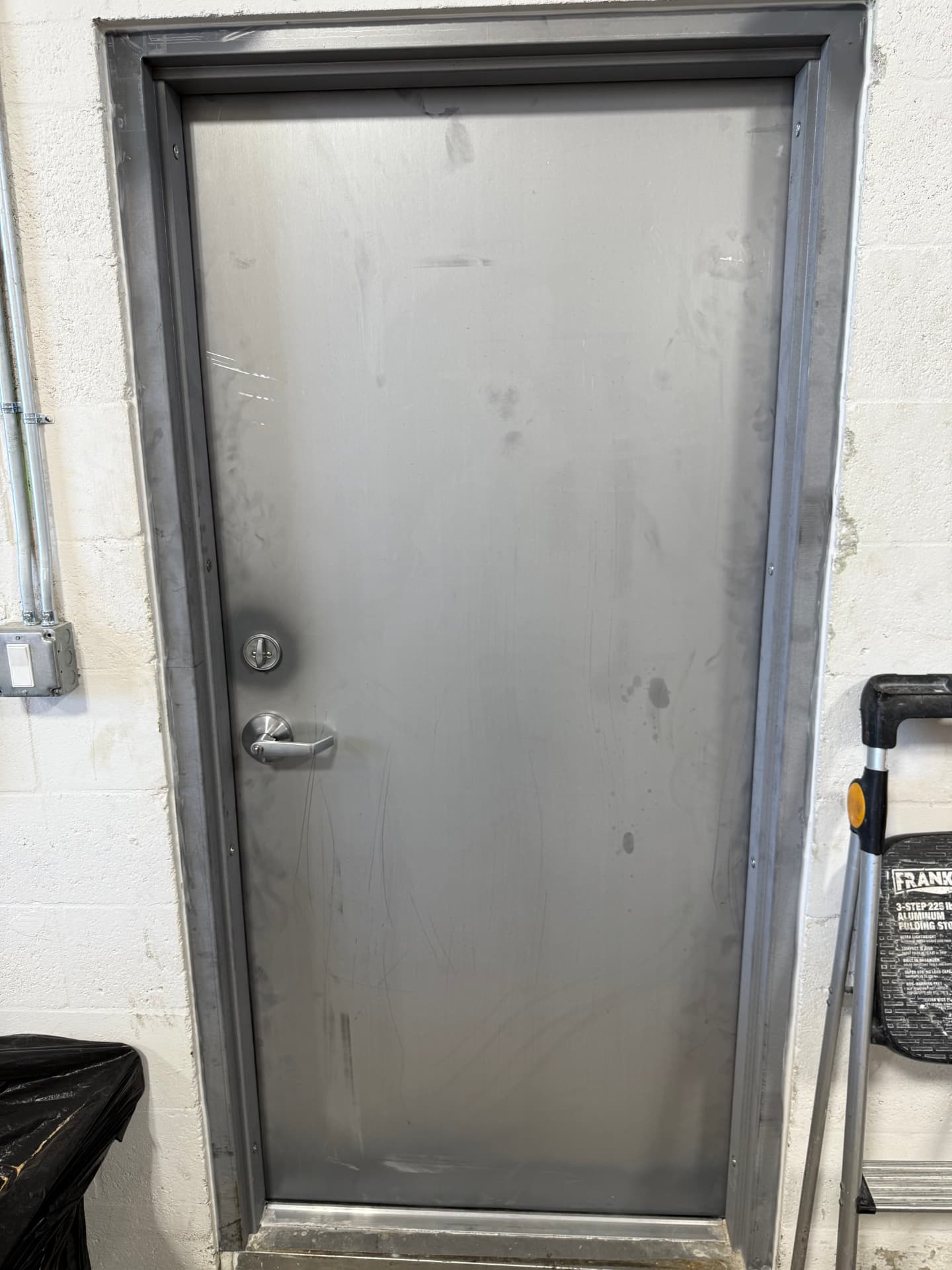 Hollow metal door with lever lockset and deadbolt