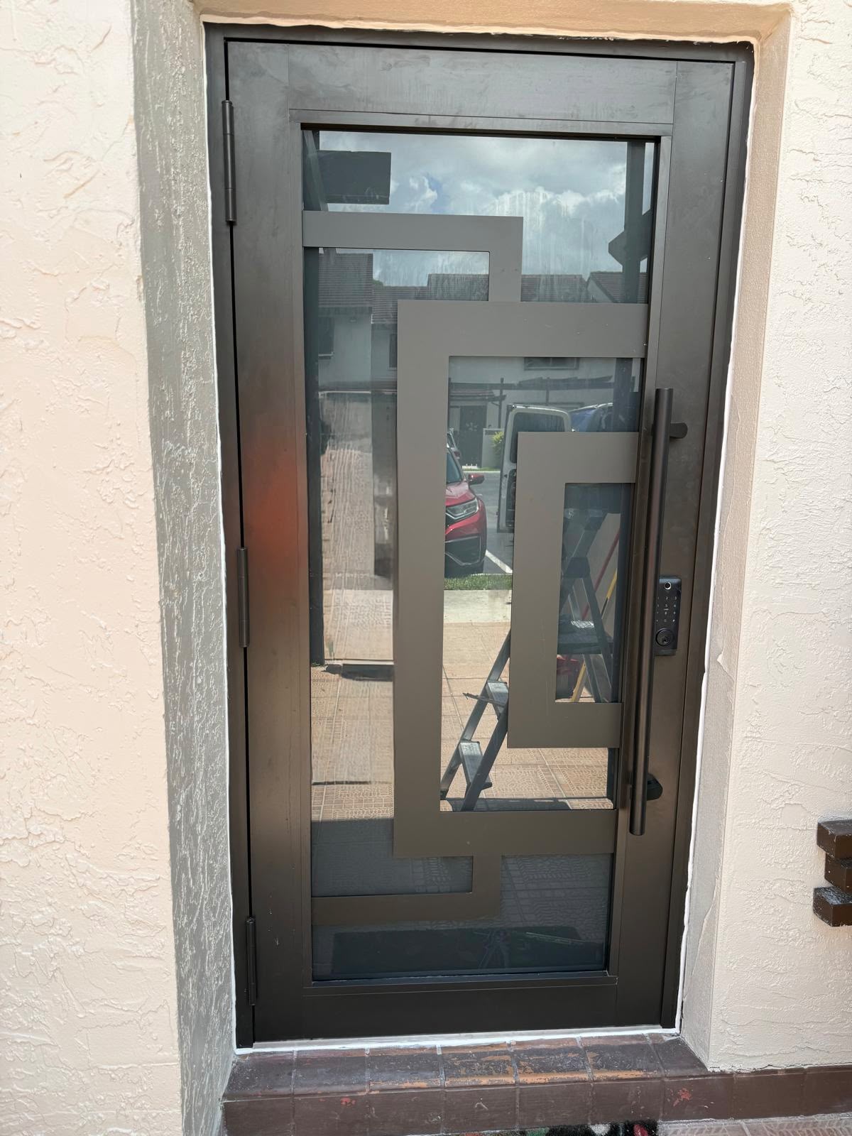 Bronze geometric aluminum door with long pull handle