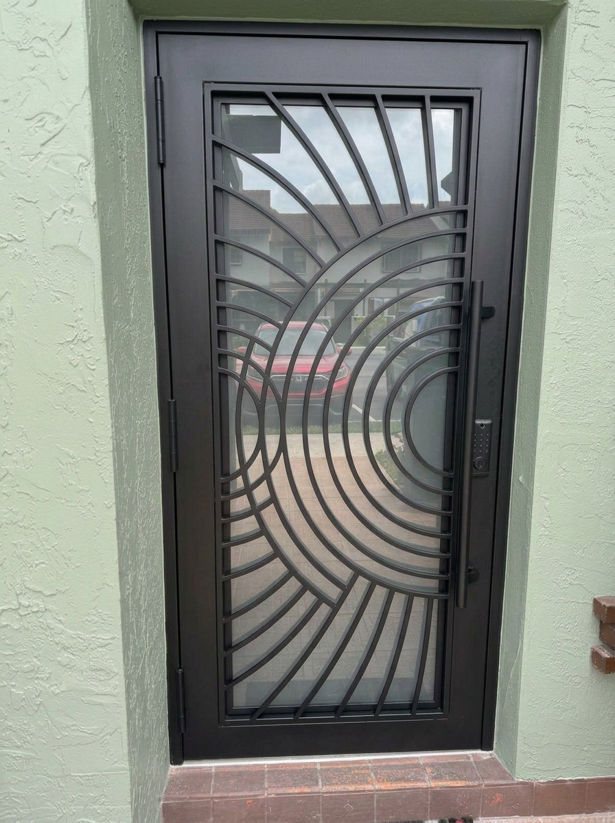 Black fan-pattern aluminum door with clear impact glass