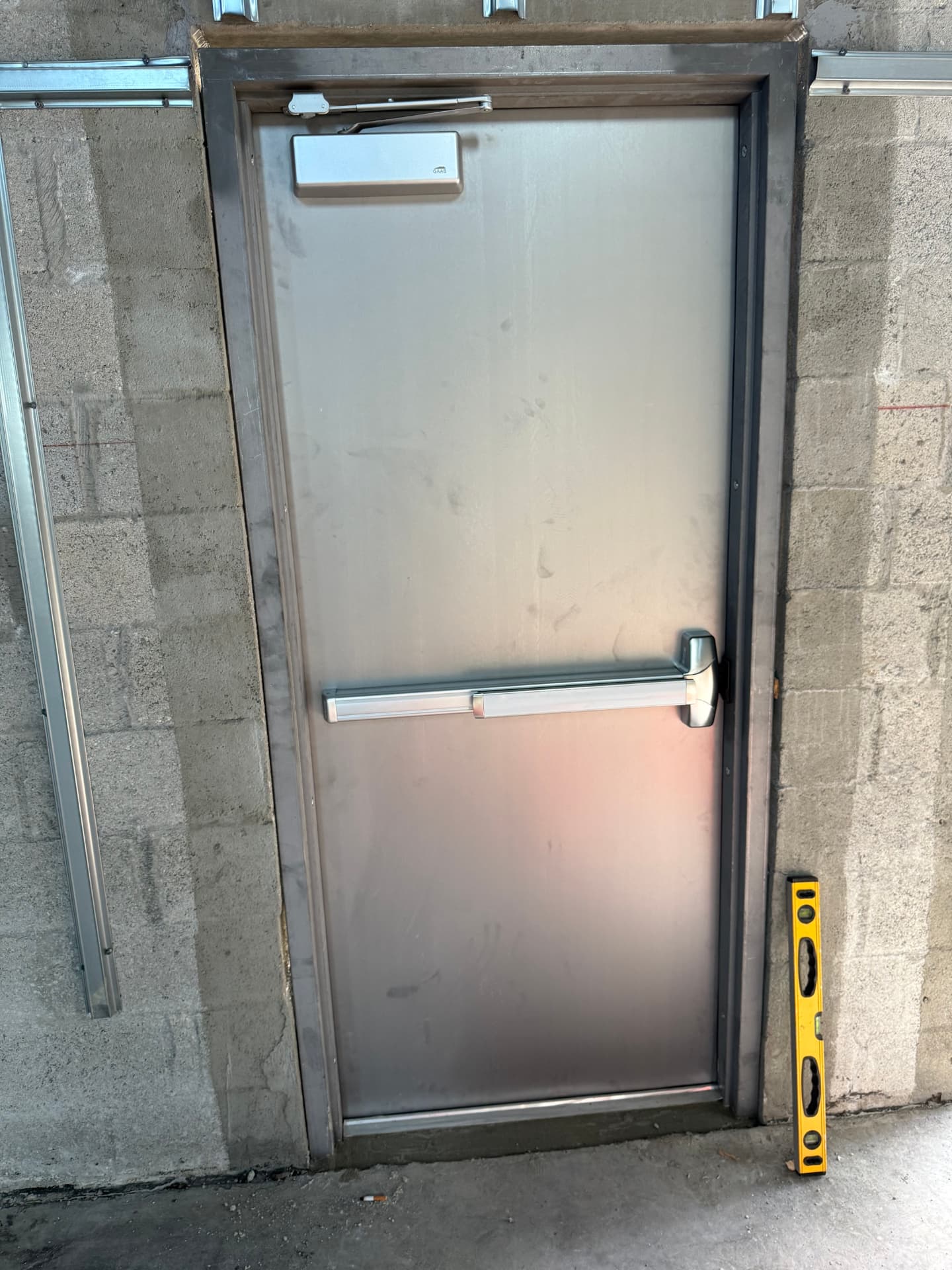 Hollow metal door with panic exit device and closer